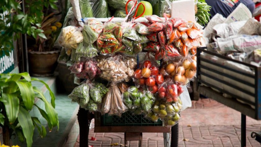 Des visiteurs explorent un marché couvert en Martinique pendant une journée pluvieuse.